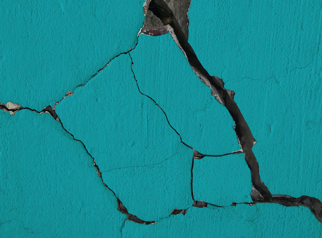 Teal coloured cracked wall