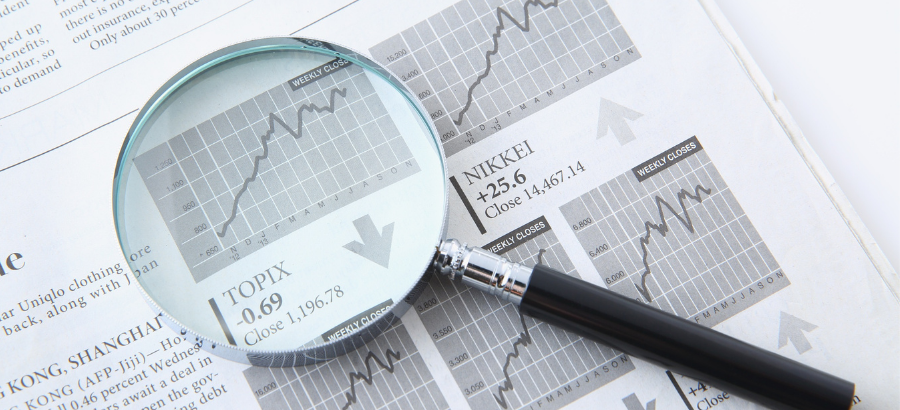 Magnifying glass with a teal tint on report with a graph}