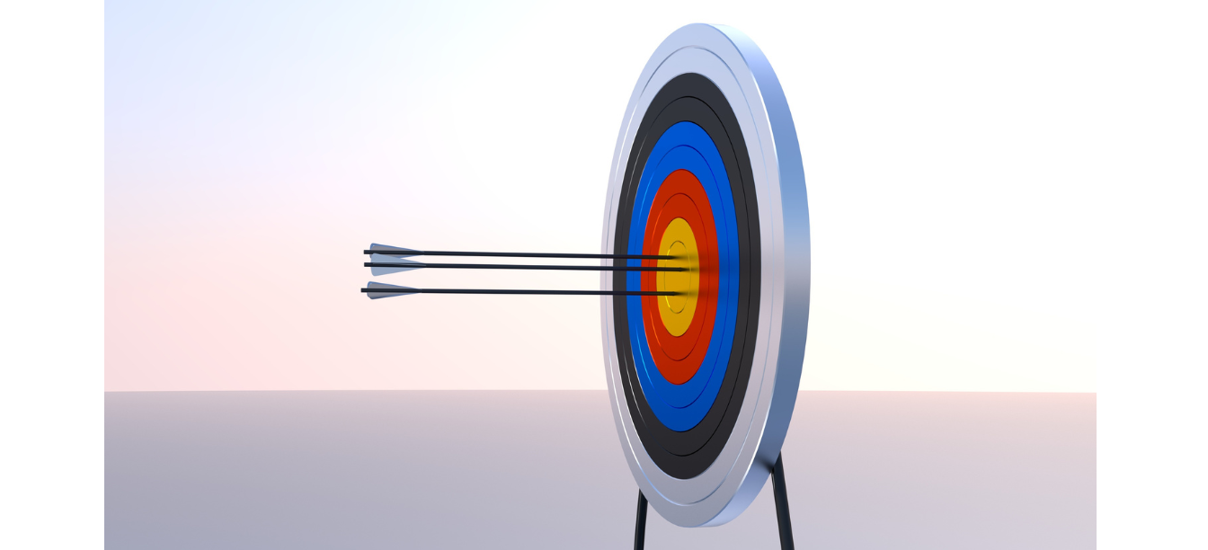 A standing target with 3 arrows in the centre bullseye 