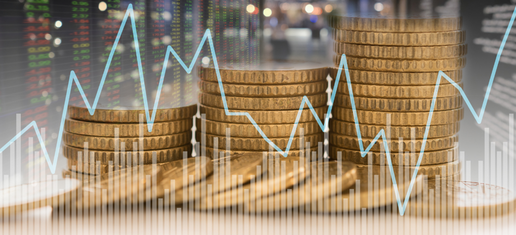 Coins Stacked with a Line Graph Showing Fluctuation in Front of Them 