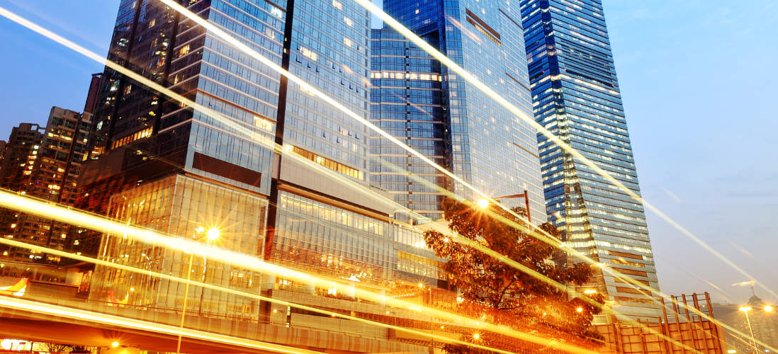 The lights of the city streak through the financial district 